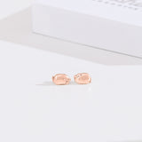 Front view of rose gold vermeil finish of Lazy Stud Earrings. The earrings are an unmatched pair of Pusheen sitting in two different loaf poses. 