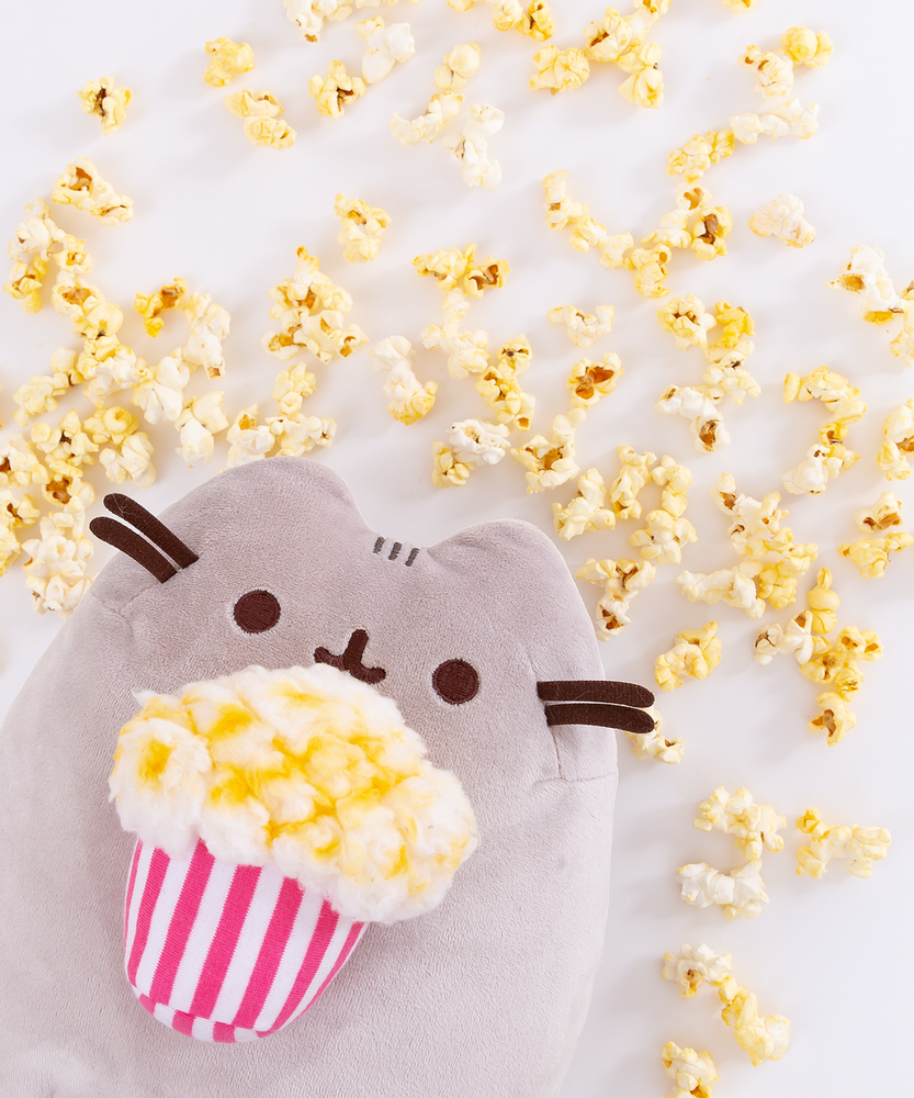 Front view of the Popcorn Pusheen Plush sitting upright in a white space.