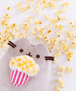Front view of the Popcorn Pusheen Plush sitting upright in a white space.