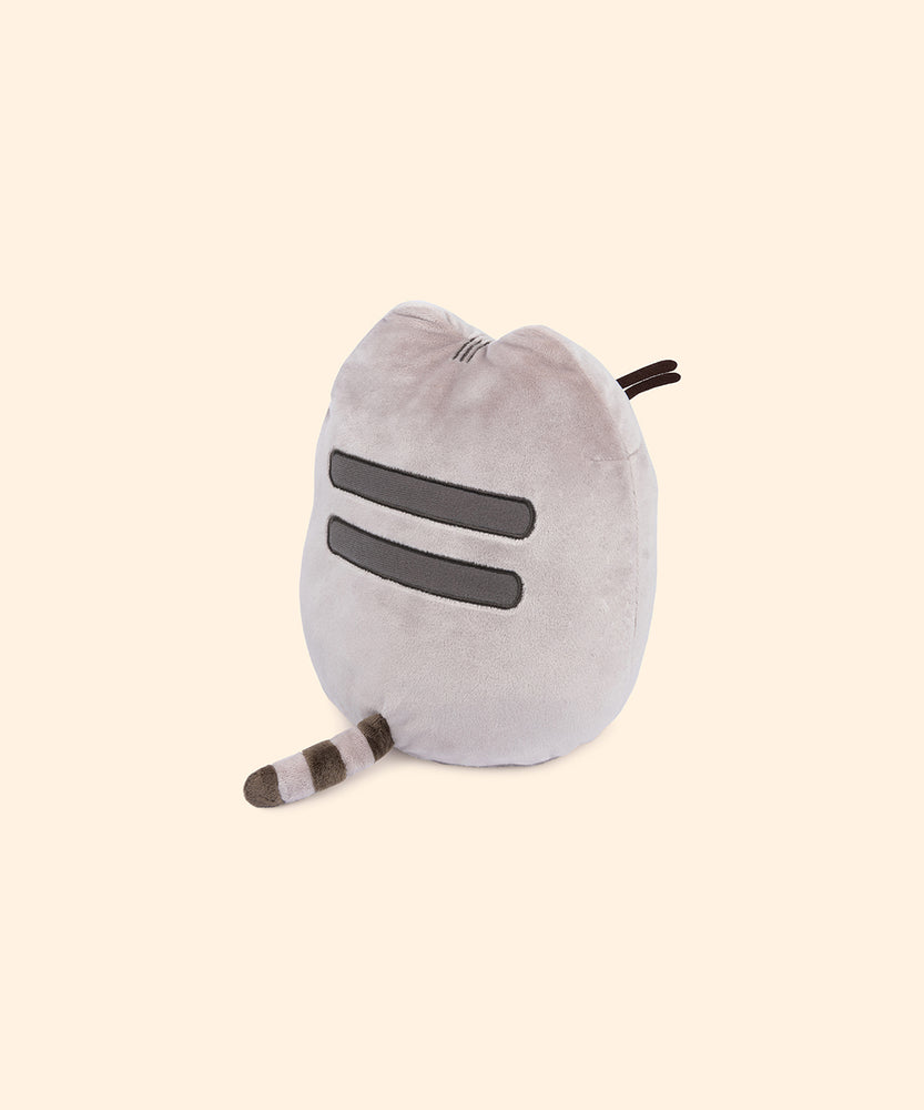 Back view of the plush shows Pusheen’s classic back stripes and striped grey tail.