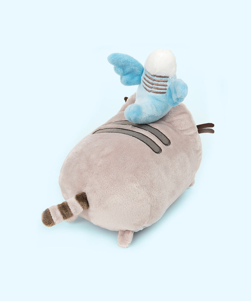 Back quarter view of the Bo and Pusheen Plush. From this angle, Bo's tail reaches out to Pusheen's first back stripe. The back of Bo's wings do not have any white feathers embroidered in. Pusheen's tail is present on the other side of the log.
