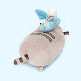 Back quarter view of the Bo and Pusheen Plush. From this angle, Bo's tail reaches out to Pusheen's first back stripe. The back of Bo's wings do not have any white feathers embroidered in. Pusheen's tail is present on the other side of the log.