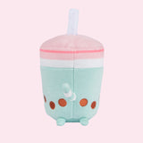 Back view of the Boba Tea Sips Plush. The back of the plush has an extended white and mint striped tail above its plush back feet and brown boba embroidery detail.  