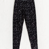 Front view of the Pusheen Celestial Leggings, on top of a white fuzzy blanket.