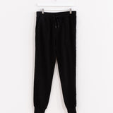 Front view of the Pusheen Celestial Jogger, hanging from a white clothes hanger in front of a white background. The pattern on the side is not visible from the front, making the item appear like a solid black jogger.