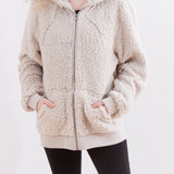 Model wearing the Pusheen Character hoodie with their hands in the pockets. The fuzzy hoodie fits loosely on the arms, while the ribbed cuffs fit more closely. 