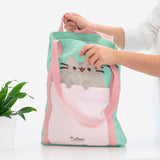 A model holds the Pusheen Deluxe Tote Bag open to show the scale and size of the bag.  