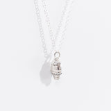 A close-up view of the side of the Pusheen Dipped Cone Necklace in Sterling Silver. The front of the charm displays Pusheen as ice cream sitting in a lattice cone. 