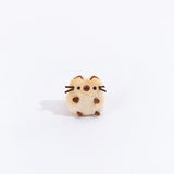 Full view of the mini Siamese cat plush from the collectors set. The cat is a light brown with dark brown paw stubs, a dark brown circle over their snout, and dark brown embroidered line on the top of their ears.