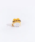 Full view of the mini worried yellow cat plush from the collectors set. The cat is a golden yellow, with a dark orange tail on the left side. Their belly has a white circle, which encompasses their feet. The cat has worried eyebrows embroidered into it, and their mouth is open.