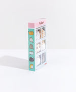 Quarter view of the Pusheen I Love Kitties Plush Collectors Set in it’s original packaging standing upright in front of a white background. The side features illustrations of the cats featured in the mini plush, starting with the winking brown cat, the Siamese, Pusheen, the annoyed white cat, the skunk, and the worried yellow cat.