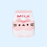 A close-up front view of the Strawberry Milk Sips Plush facing forward on a light blue background. 