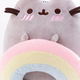 Close up of the Pusheen with Rainbow Plush. Pusheen’s front paws are sewn into the rainbow she’s holding, which is it’s own separate rounded plush. The texture of the rainbow is slightly more fuzzier then Pusheen’s fur.