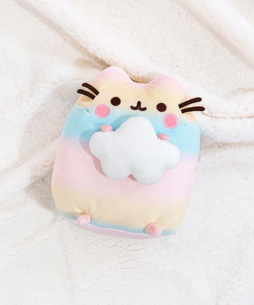 Back view of the Rainbow Pusheen Plush in front of a light blue background. Pusheen's two back stripes are white and embroidered into the plush. Pusheen's tail is a light pastel pink with white stripes. The plush is in front of a light blue background.