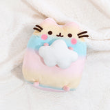 Top view of the Rainbow Pusheen Plush laying down on top of a fuzzy white blanket.