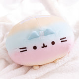 Close-up of the embroidered Pusheen face detail. The embroidered thread is a brown color.  In between the ears of the plush are three, white embroidered stripes.  