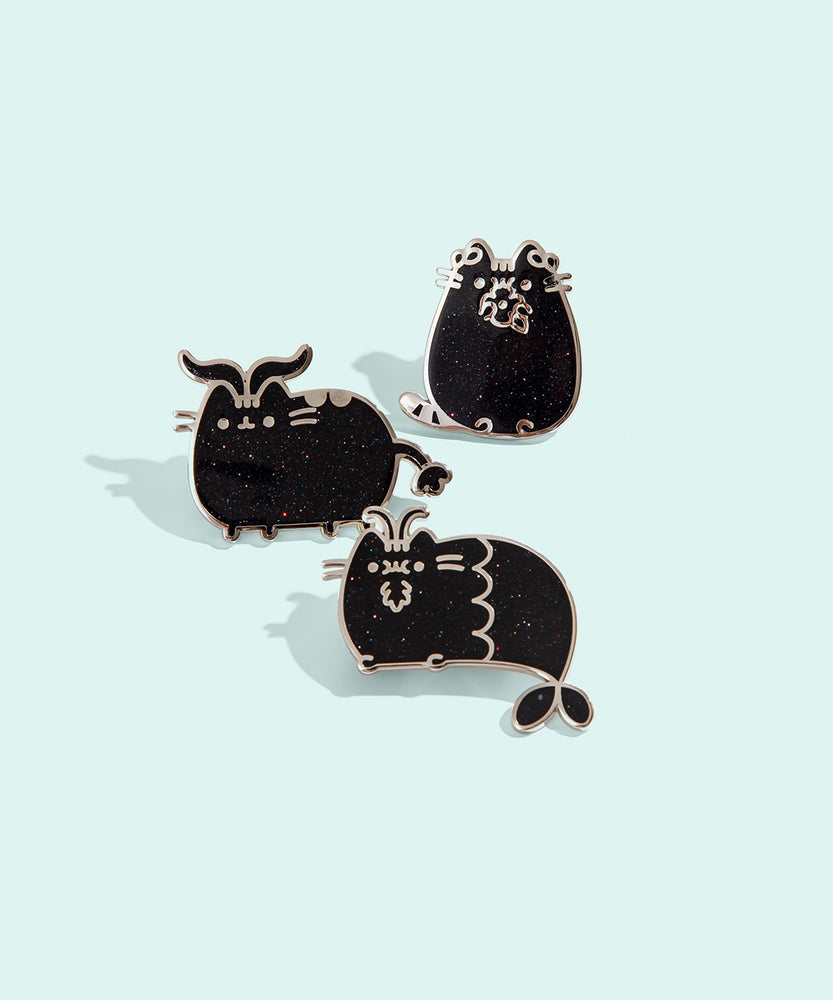 Group photo of three of the metallic Pusheen horoscope pins, featuring Pusheen as the three horoscope signs, Capricorn, Taurus, and Virgo