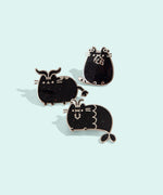 Group photo of three of the metallic Pusheen horoscope pins, featuring Pusheen as the three horoscope signs, Capricorn, Taurus, and Virgo