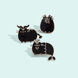 Group photo of three of the metallic Pusheen horoscope pins, featuring Pusheen as the three horoscope signs, Capricorn, Taurus, and Virgo